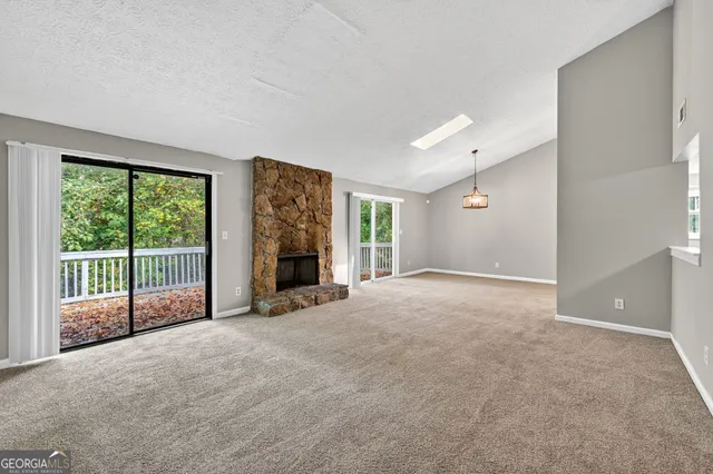a view of a livingroom with an empty space and balcony