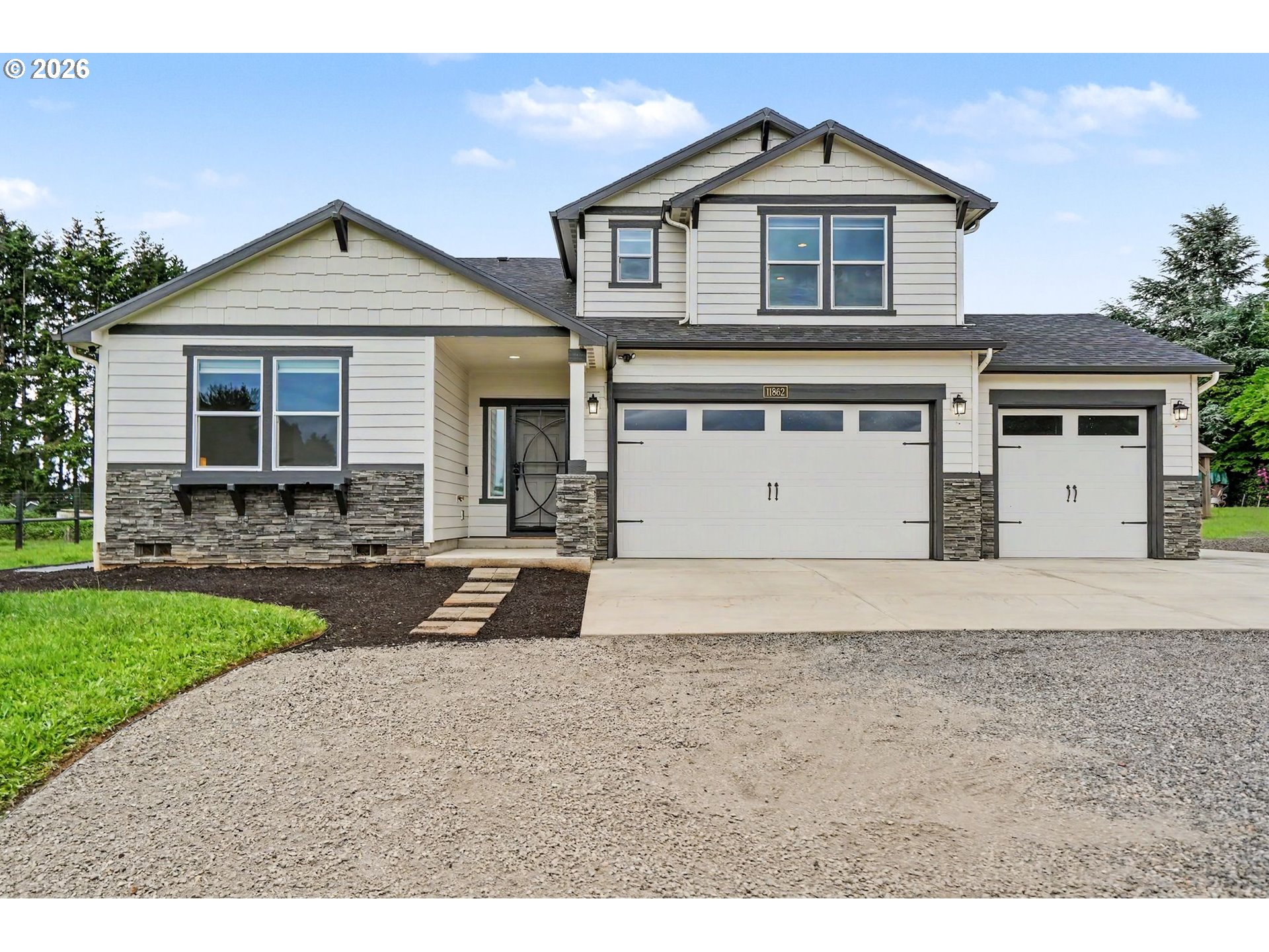 11862 Steinkamp Road Southeast Aumsville, OR 97325 - Photo 2 of 48 a front view of a house with a yard and garage