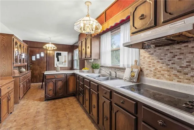 a kitchen with stainless steel appliances granite countertop a sink and cabinets