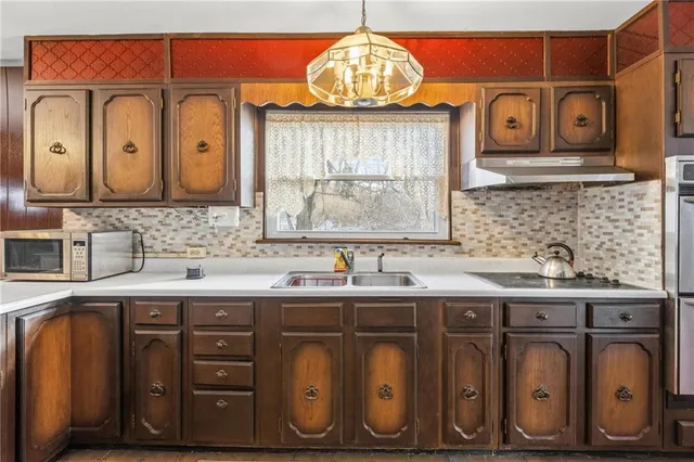 a kitchen with stainless steel appliances granite countertop a sink a stove and cabinets