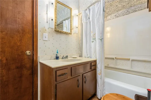 a spacious bedroom with a bed and a chandelier