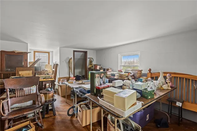 a living room with furniture a rug and white walls