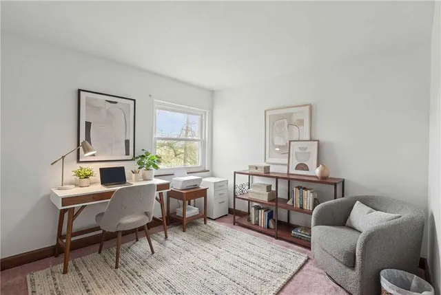 a living room with furniture a flat screen tv and a window