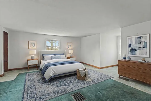 a bedroom with furniture and a large window