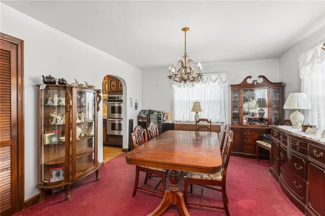 a view of a dining room with furniture and chandelier