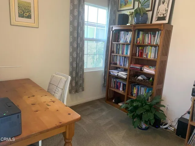 a bedroom with a bed and a book shelf