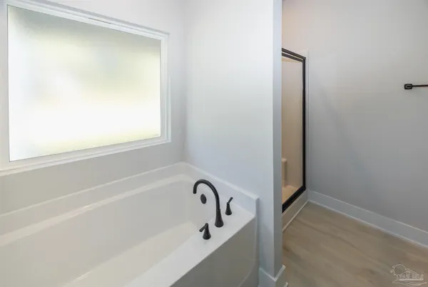a bathroom with a granite countertop sink a mirror and a shower