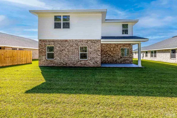 a view of a house with a backyard