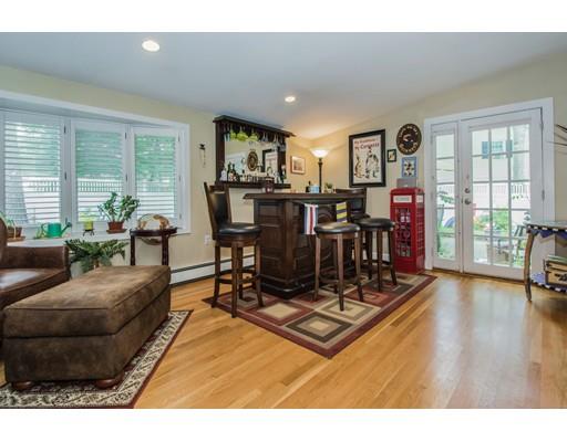 52 Harland Road Waltham, MA 02453 - Photo 14 of 37 a living room with furniture a wooden floor and a large window