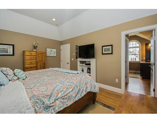 52 Harland Road Waltham, MA 02453 - Photo 23 of 37 a bedroom with a bed and a flat screen tv