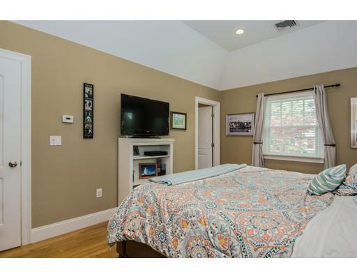 52 Harland Road Waltham, MA 02453 - Photo 24 of 37 a bedroom with a bed and a flat screen tv