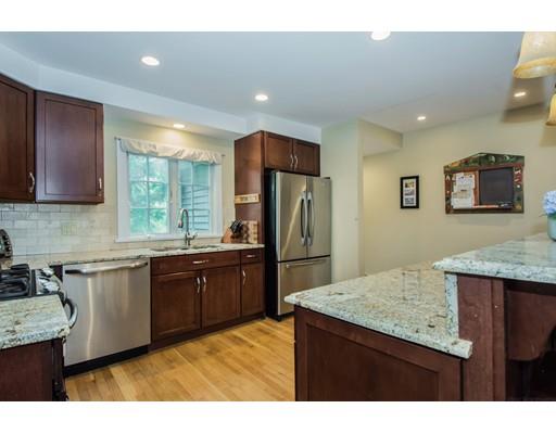 52 Harland Road Waltham, MA 02453 - Photo 3 of 37 a kitchen with stainless steel appliances granite countertop a sink stove and refrigerator
