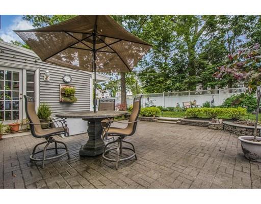 52 Harland Road Waltham, MA 02453 - Photo 36 of 37 a view of a patio with table and chairs under an umbrella