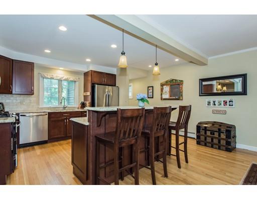 52 Harland Road Waltham, MA 02453 - Photo 4 of 37 a kitchen with stainless steel appliances kitchen island granite countertop a table chairs and a refrigerator