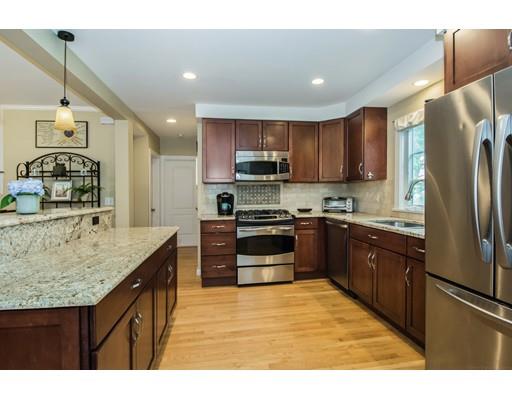 52 Harland Road Waltham, MA 02453 - Photo 6 of 37 a kitchen with stainless steel appliances granite countertop a sink stove and refrigerator
