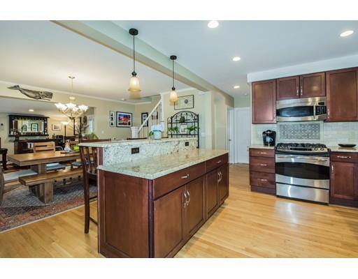 52 Harland Road Waltham, MA 02453 - Photo 7 of 37 a kitchen with stainless steel appliances granite countertop a stove and a refrigerator
