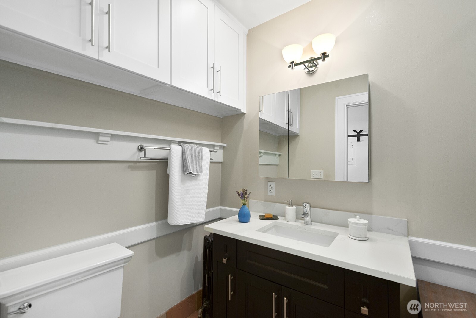 4915 Linden Avenue North, Unit 1 Seattle, WA 98103 - Photo 12 of 18 a bathroom with a sink vanity and a mirror