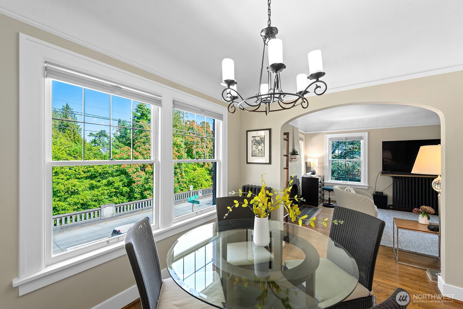 4915 Linden Avenue North, Unit 1 Seattle, WA 98103 - Photo 7 of 18 a view of a dining room with furniture a chandelier and large windows