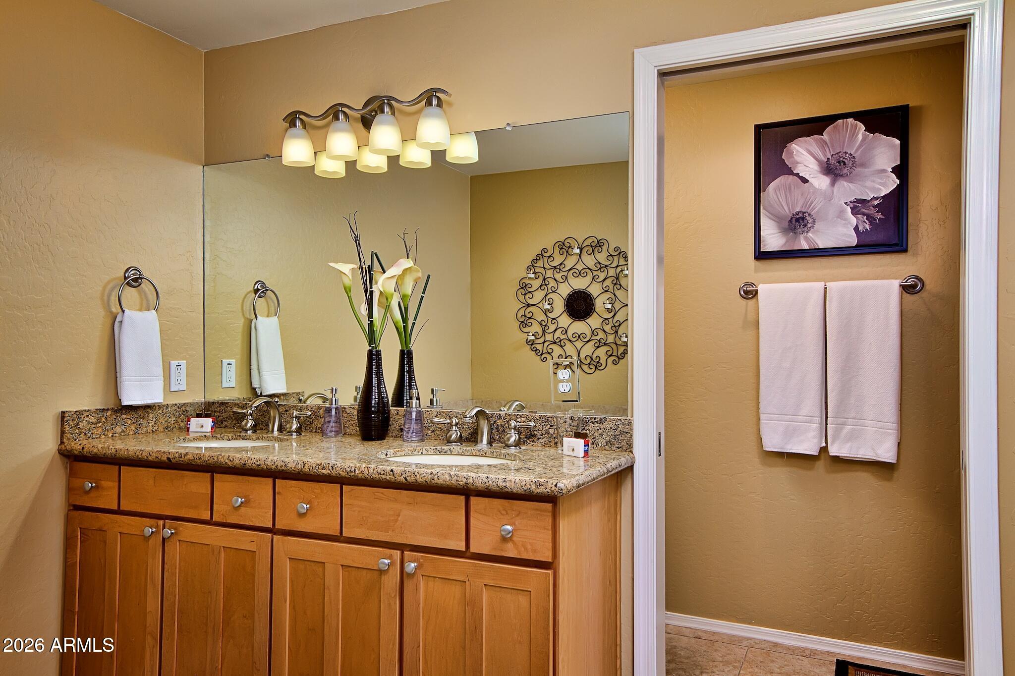 7609 East Indian Bend Road, Unit 3002 Scottsdale, AZ 85250 - Photo 13 of 19 a bathroom with a sink and a mirror
