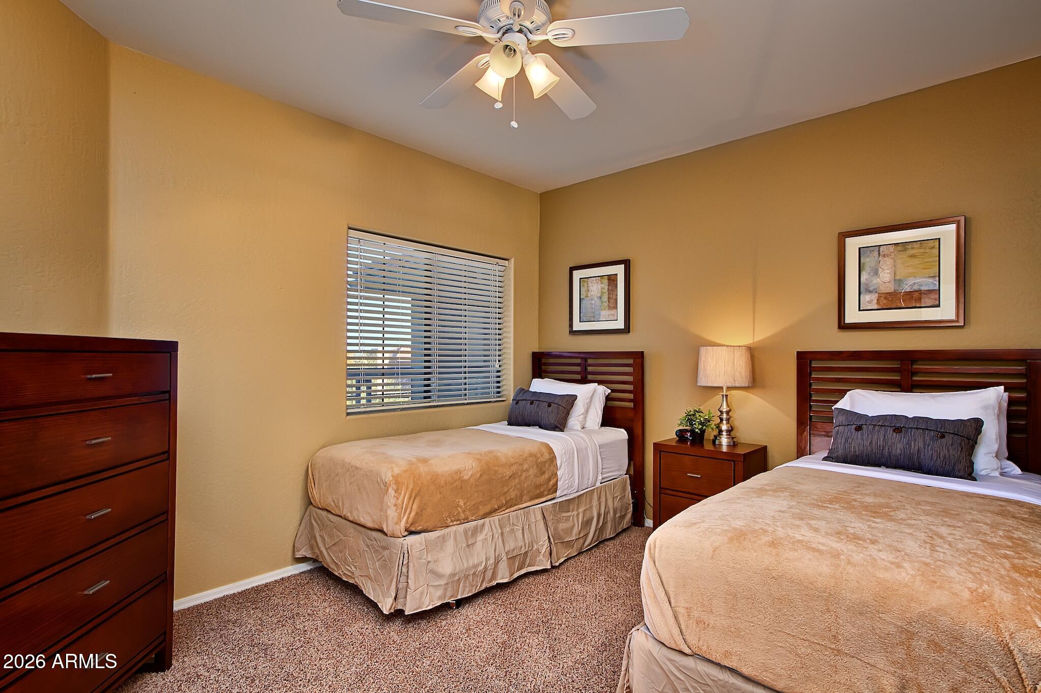 7609 East Indian Bend Road, Unit 3002 Scottsdale, AZ 85250 - Photo 14 of 19 a bedroom with two beds and painting on the wall