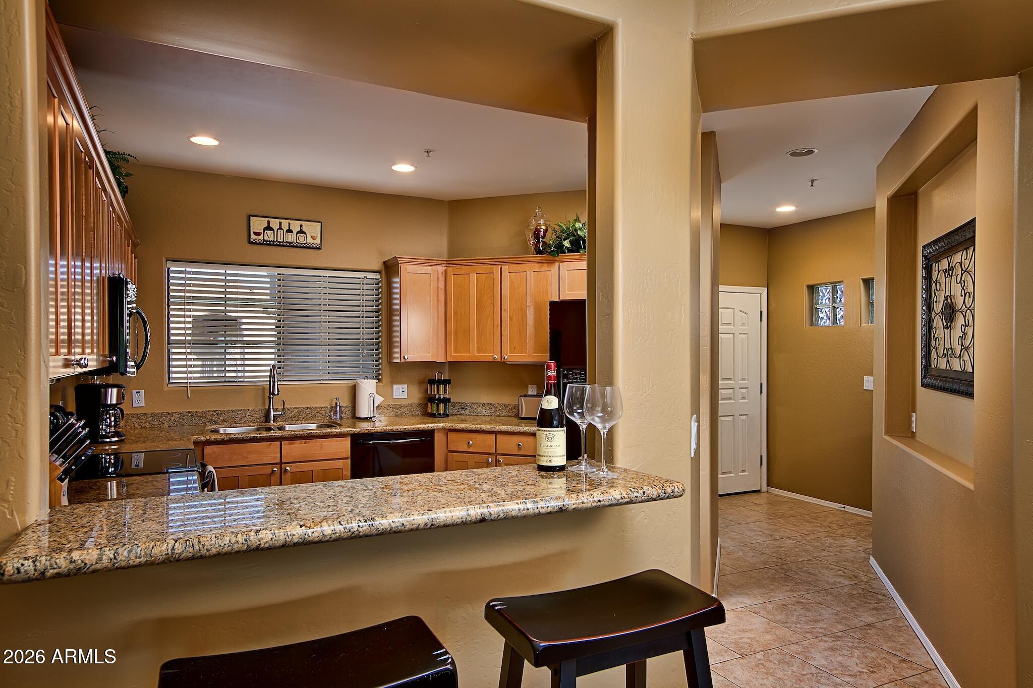 7609 East Indian Bend Road, Unit 3002 Scottsdale, AZ 85250 - Photo 4 of 19 a kitchen with center island table and chairs