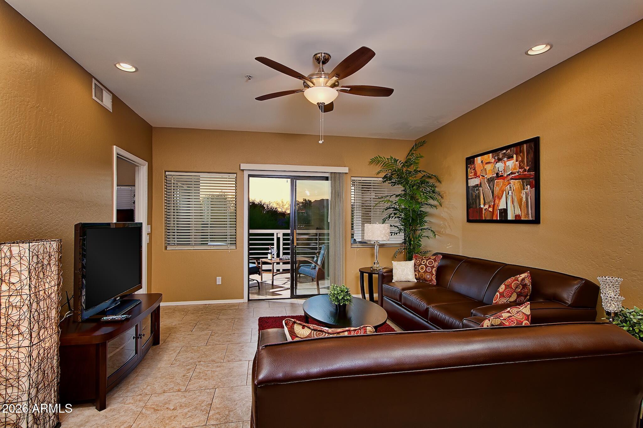7609 East Indian Bend Road, Unit 3002 Scottsdale, AZ 85250 - Photo 7 of 19 a living room with furniture and a flat screen tv