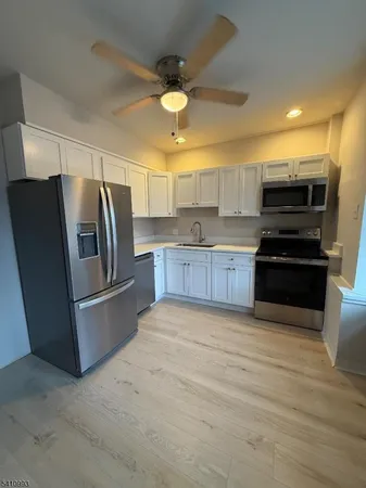 a kitchen with stainless steel appliances a refrigerator and a stove