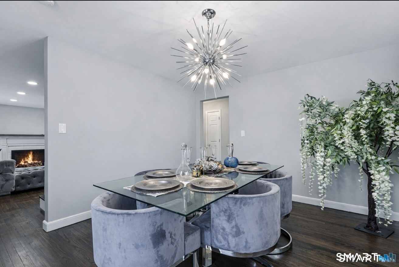 457 Summit Street Bridgeport, CT 06606 - Photo 5 of 9 a dining room with furniture potted plants and wooden floor
