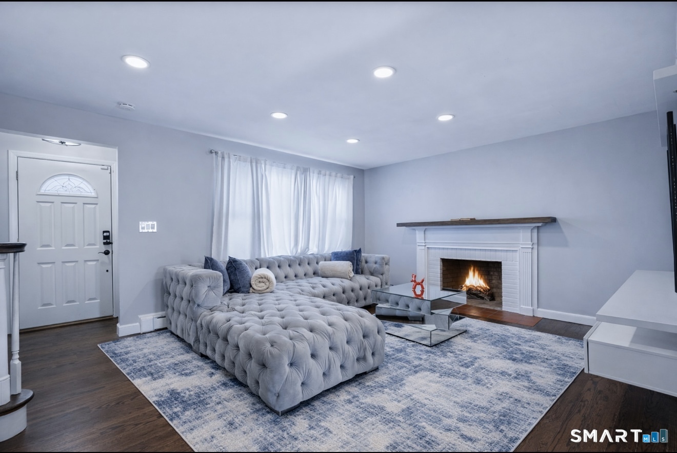 457 Summit Street Bridgeport, CT 06606 - Photo 7 of 9 a living room with furniture and a fireplace