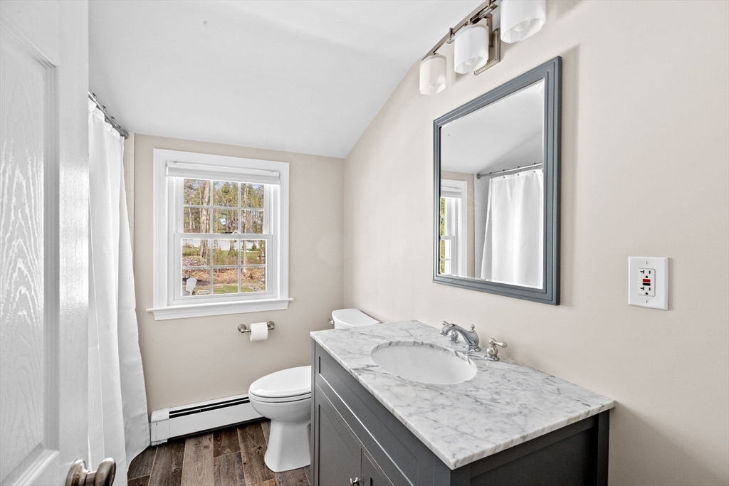 47 Deborah Road Hanover, MA 02339 - Photo 13 of 22 a bathroom with a granite countertop toilet a sink and a mirror