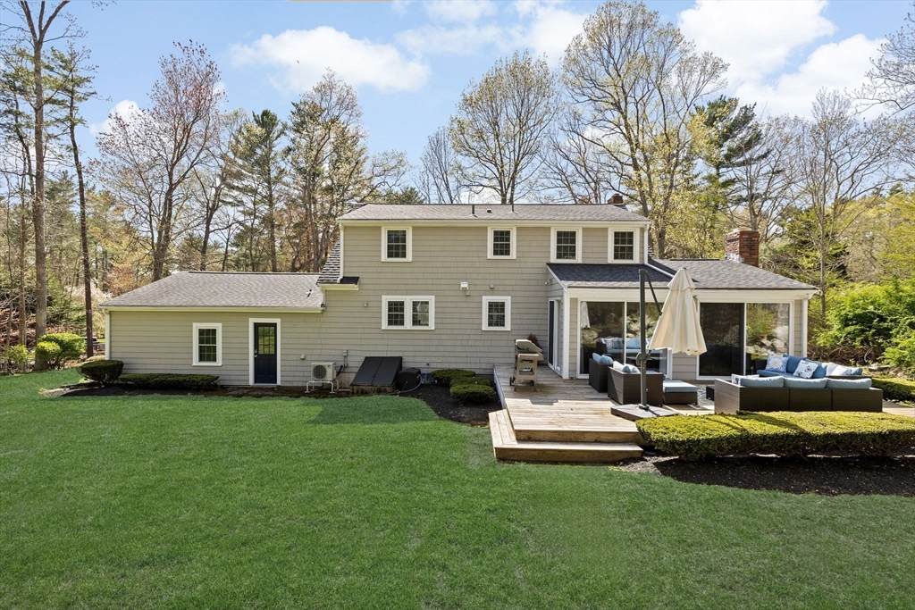47 Deborah Road Hanover, MA 02339 - Photo 18 of 22 a front view of a house with a garden and trees