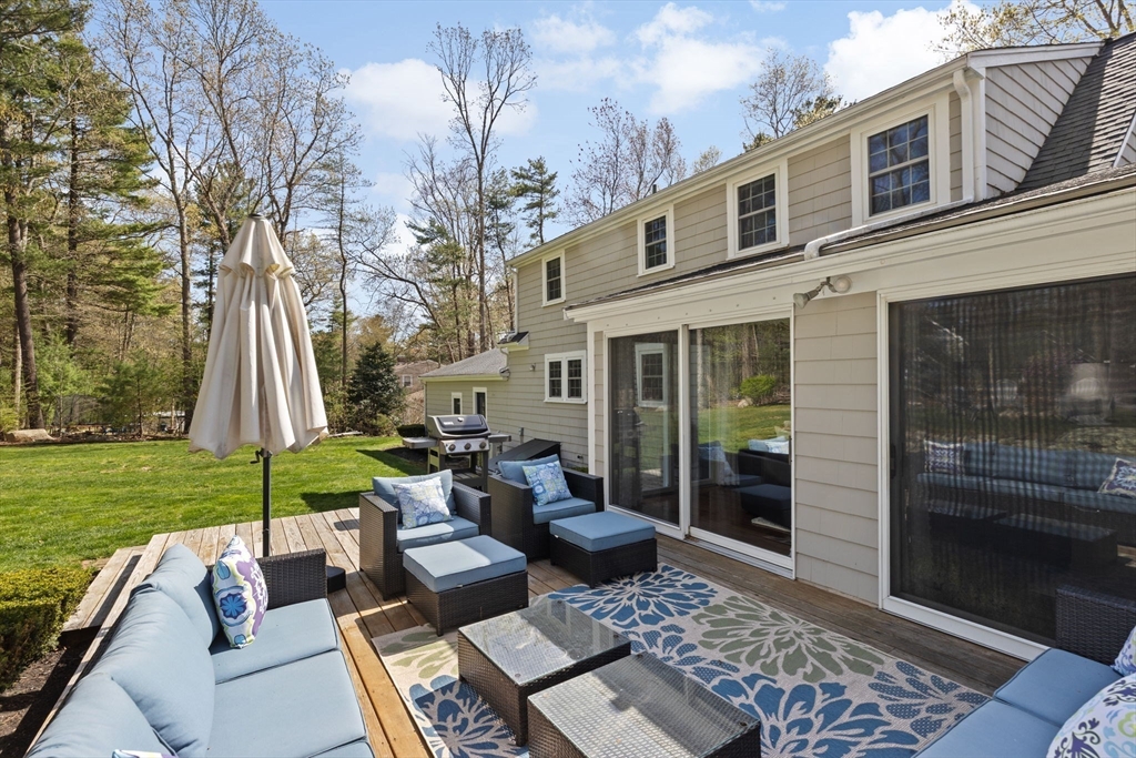 47 Deborah Road Hanover, MA 02339 - Photo 19 of 22 a view of a patio with table and chairs potted plants and a large tree