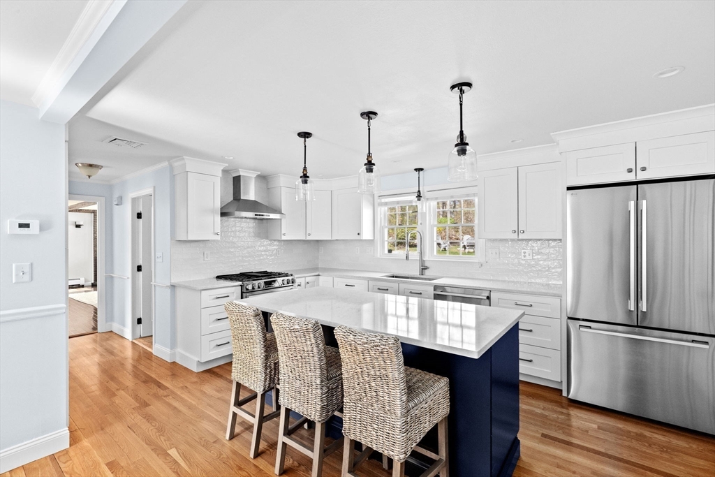 47 Deborah Road Hanover, MA 02339 - Photo 3 of 22 a kitchen with stainless steel appliances granite countertop a dining table chairs stove refrigerator and cabinets