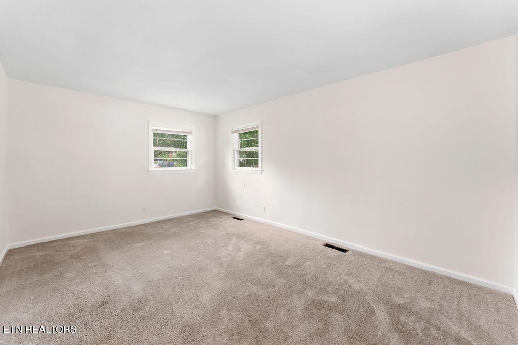 114 Tucker Road Oak Ridge, TN 37830 - Photo 7 of 22 an empty room with windows