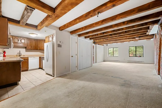 a view of a kitchen with a sink and refrigerator