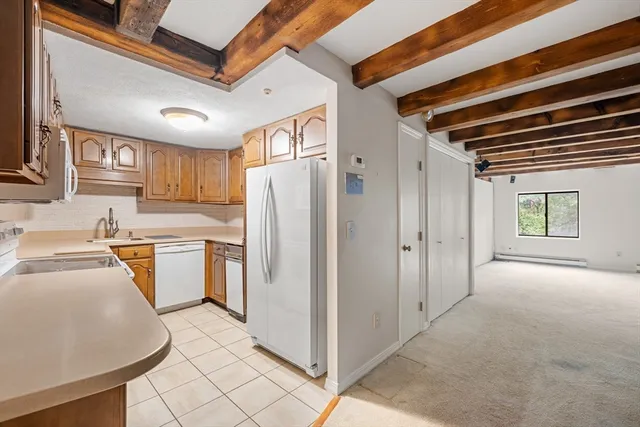 a kitchen with refrigerator and cabinets