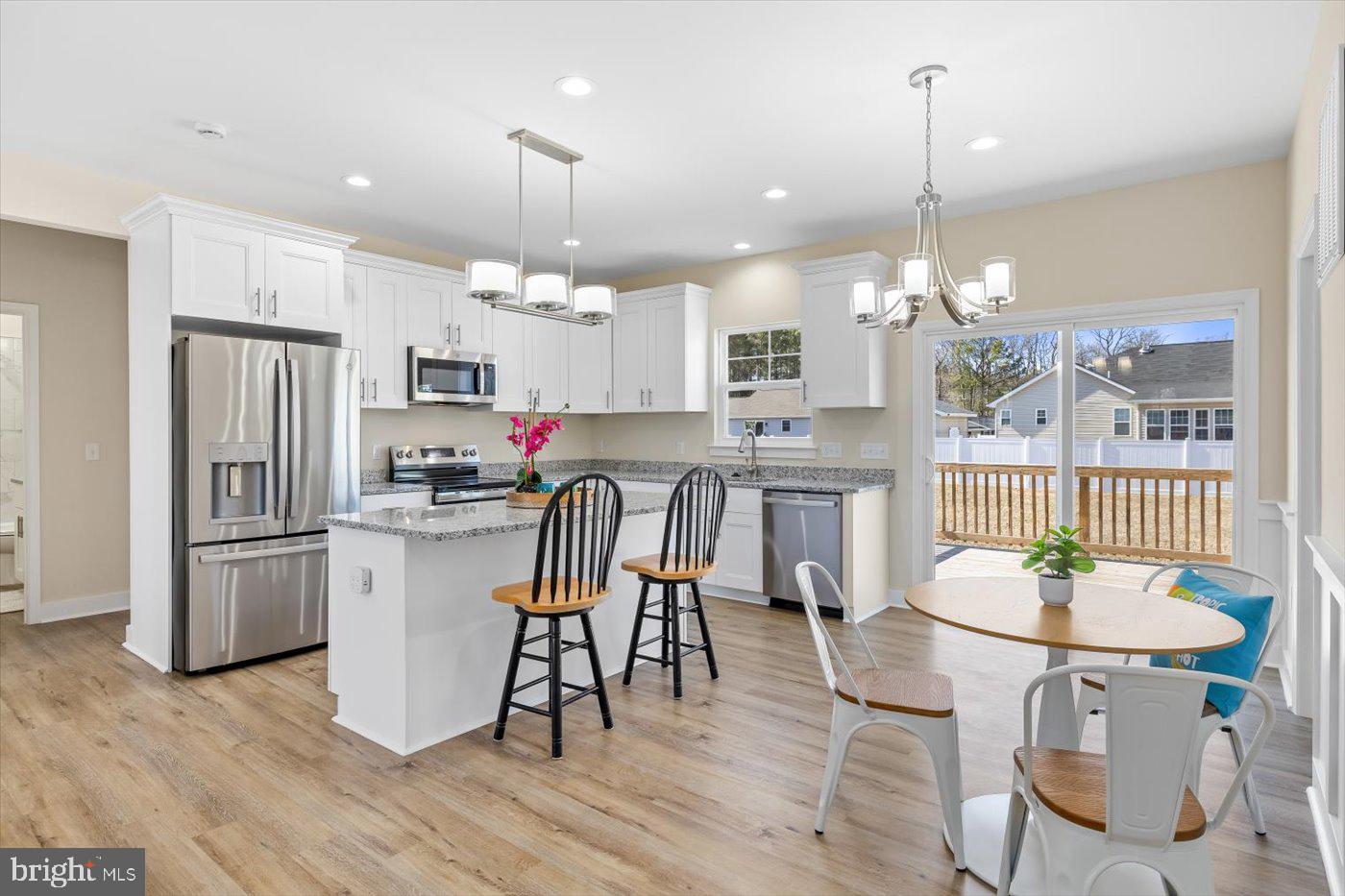 1419 South Glebe Road Montross, VA 22520 - Photo 31 of 76 a kitchen with stainless steel appliances kitchen island granite countertop a refrigerator a stove a kitchen island with a dining table and chairs