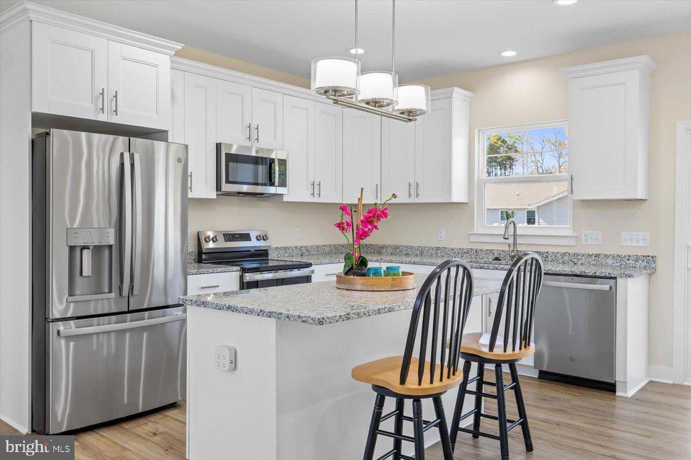 1419 South Glebe Road Montross, VA 22520 - Photo 32 of 76 a kitchen with granite countertop stainless steel appliances a refrigerator microwave and stove top oven