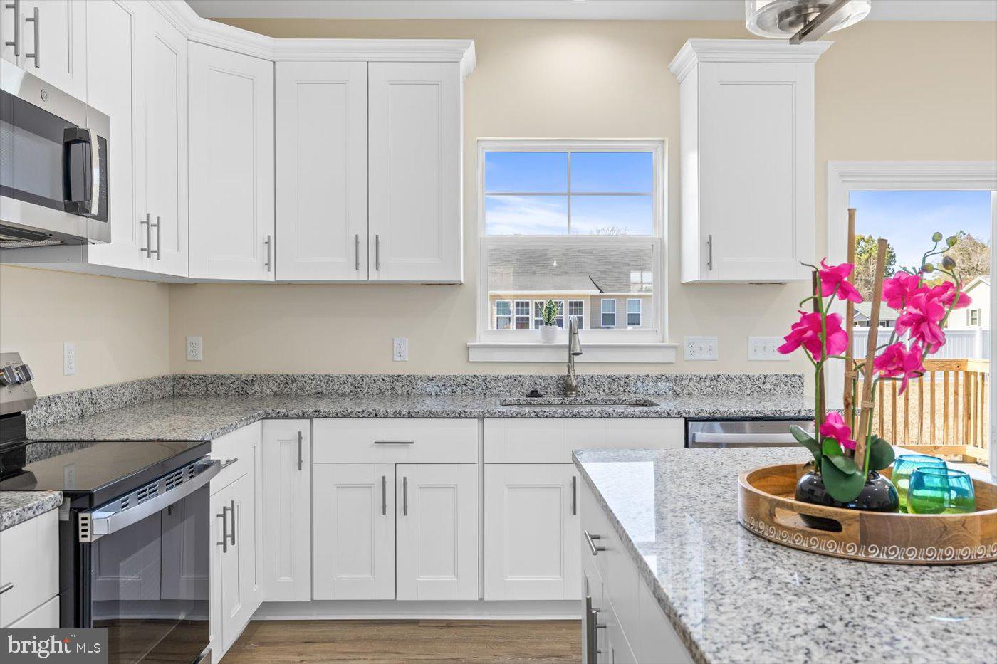 1419 South Glebe Road Montross, VA 22520 - Photo 35 of 76 a kitchen with granite countertop a stove a sink and a cabinets