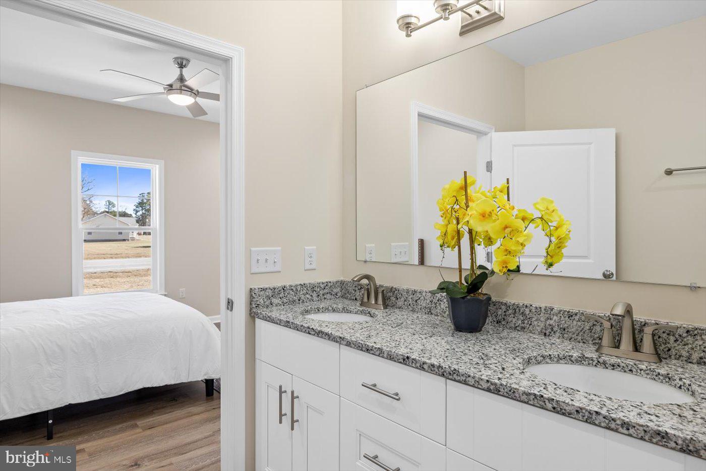 1419 South Glebe Road Montross, VA 22520 - Photo 45 of 76 a bedroom with a granite counter top a sink and a mirror