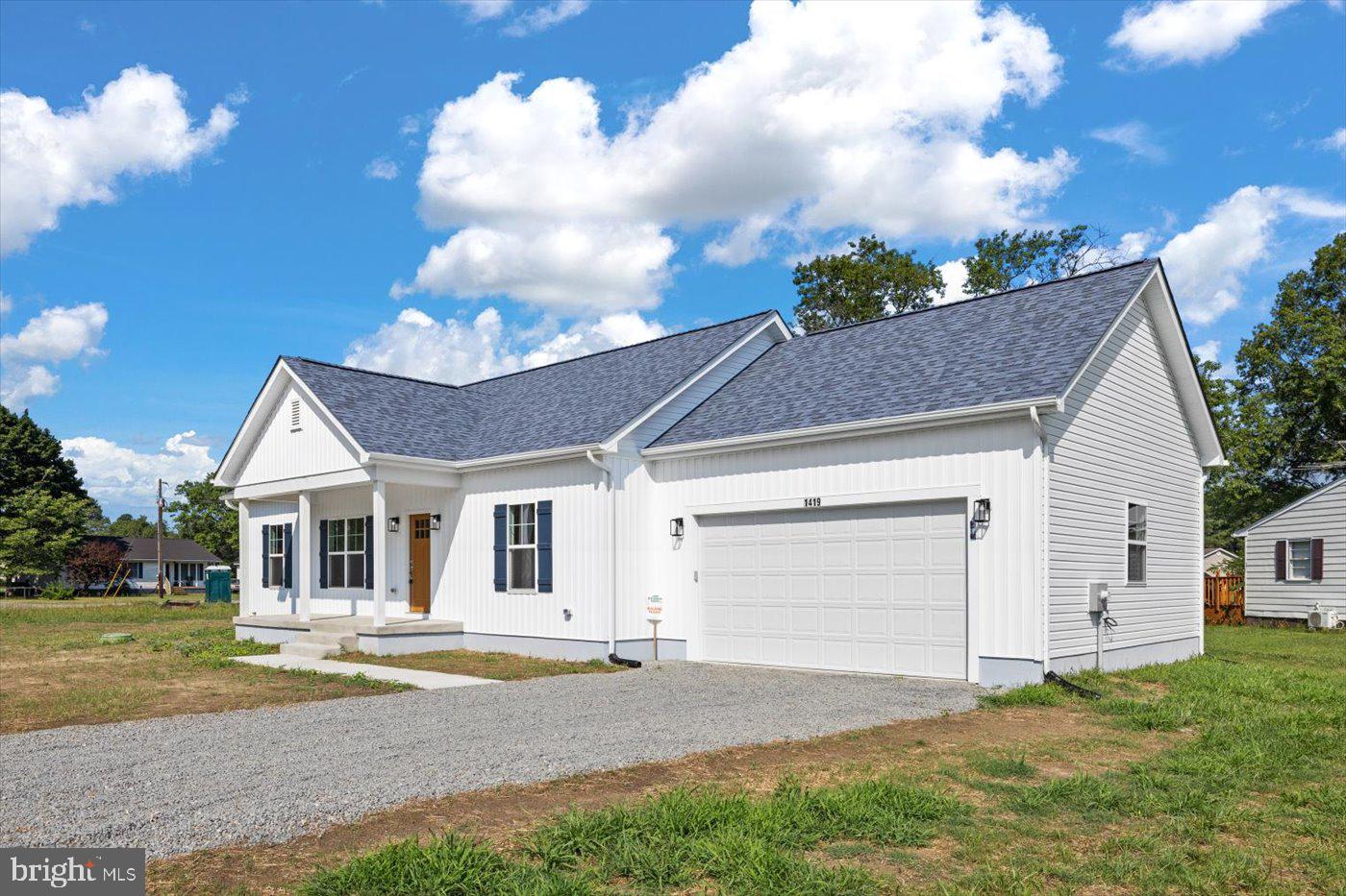 1419 South Glebe Road Montross, VA 22520 - Photo 72 of 76 a front view of a house with a yard and garage