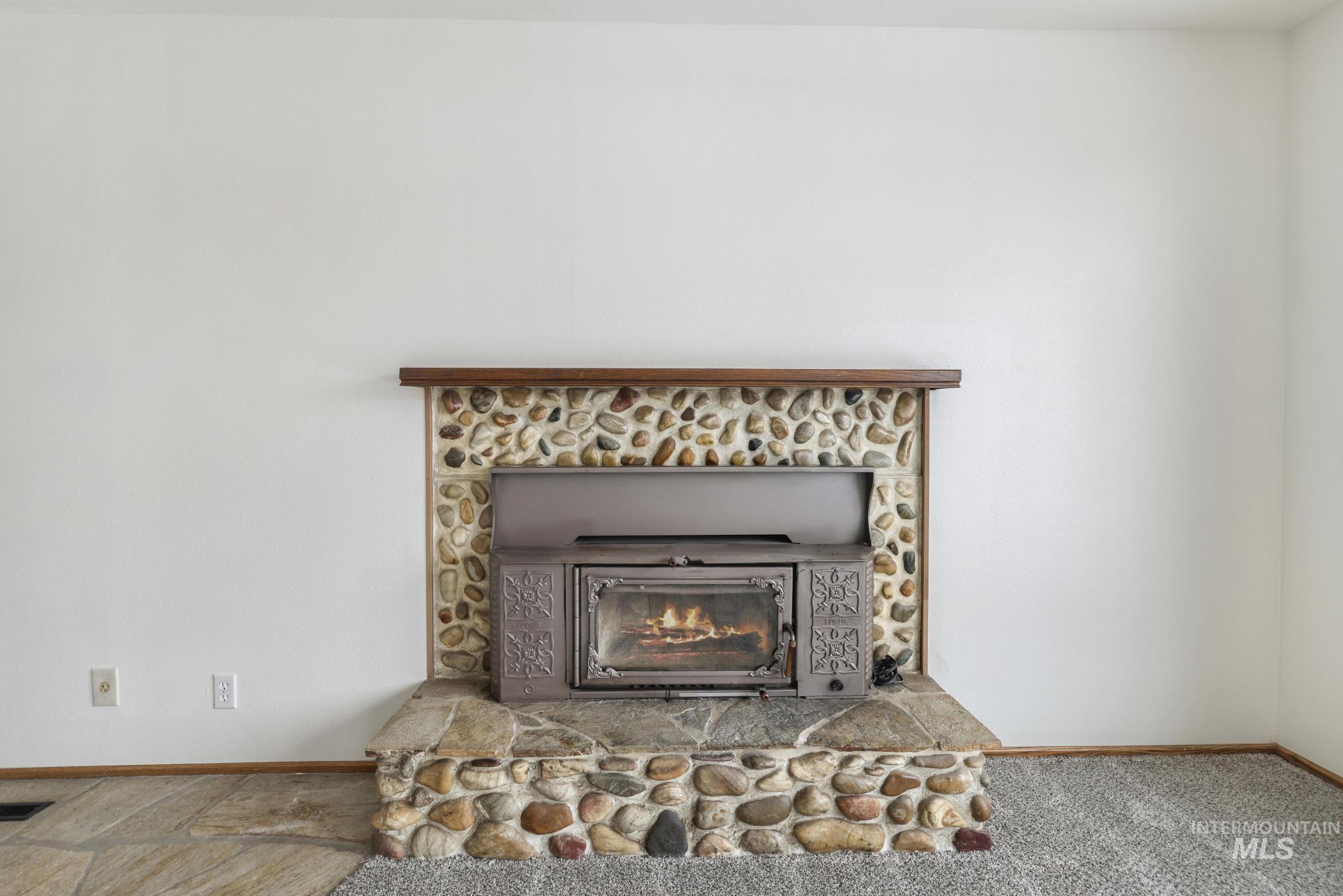 409 Clear Lakes Road Buhl, ID 83316 - Photo 14 of 43 Detailed view of baseboards and a stone fireplace
