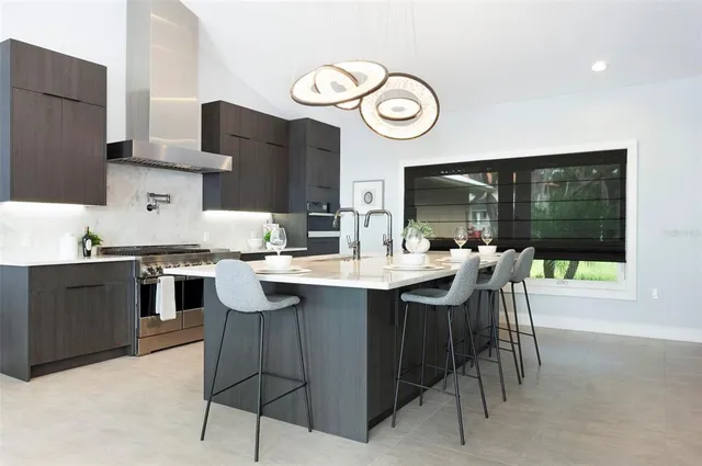 a living room with fireplace furniture and a large window