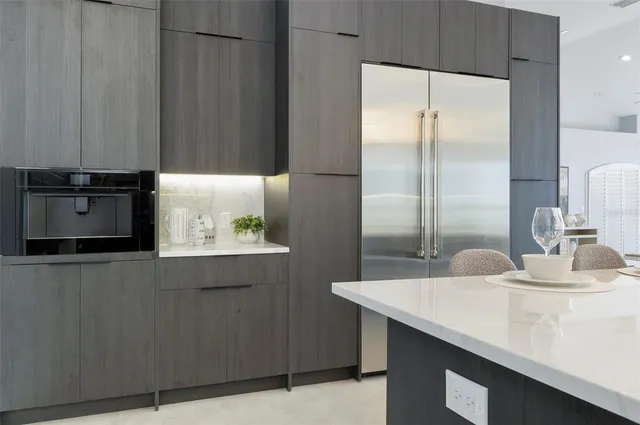 a bedroom with a large bed and a potted plant