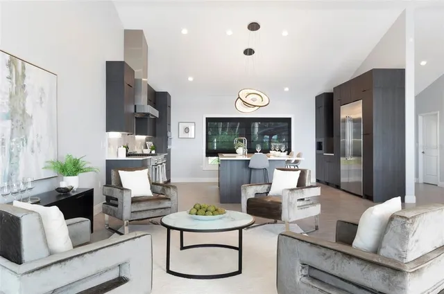a kitchen with stainless steel appliances granite countertop a sink and a refrigerator