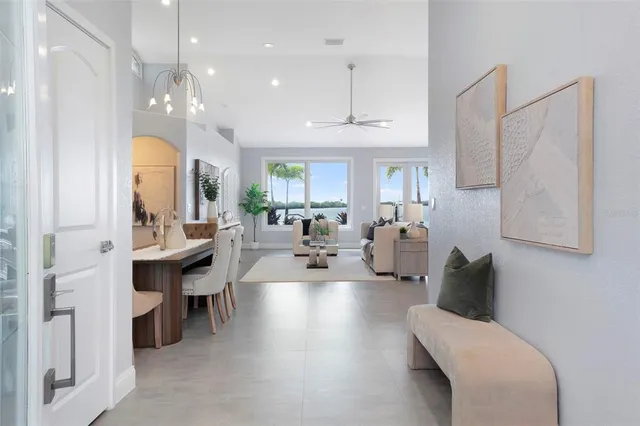 a living room with furniture and a chandelier
