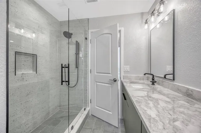 an aerial view of a house with a yard and lake view