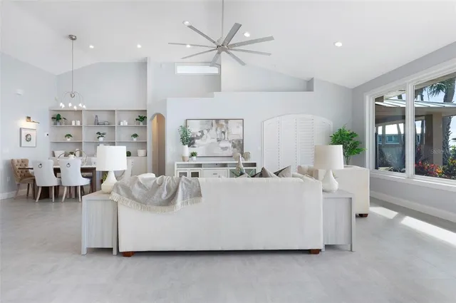 a living room with furniture and kitchen view