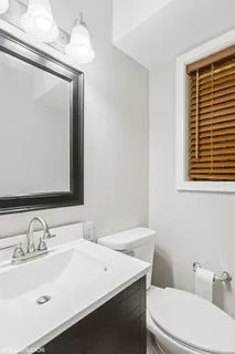 a bathroom with a sink a toilet and mirror
