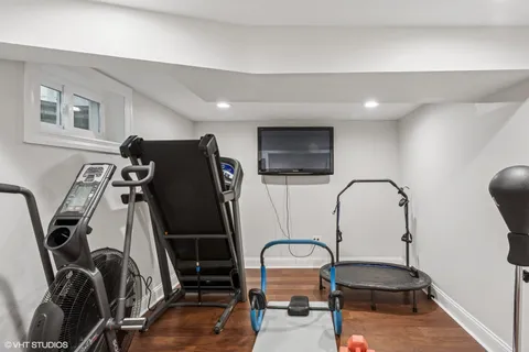 a living room with furniture a flat screen tv and a window